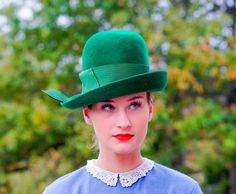 "DESCRIPTION * Vintage mod hat from 1950s-1960s * cloche style: close-fitting high round crown, designed to be worn low on the forehead, with slight brim, upturned on one side * made with wool material in Christmas green color * hatband is wrapped with a thick grosgrain ribbon embellished with a fold on the side * label reads \"Peachfelt, 100% Wool, Henry Pollak, Inc, New York\" Union made tag is illegible. CONDITION * the hat is in good vintage condition with a tiny hole the brim as shown in th Vintage Fitted Felt Hat, Vintage Fitted Wide Brim Cloche Hat, Retro Fitted Cloche Hat, Vintage Wide Brim Fitted Cloche Hat, Fitted Wide Brim Vintage Cloche Hat, Retro Fitted Brimmed Felt Hat, Retro Fitted Cloche Hat With Short Brim, Fitted Vintage Felt Hat For Spring, Retro Wide Brim Hats For Vintage Events