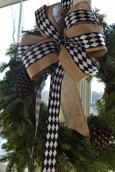 the wreath is decorated with black and white checkered ribbon