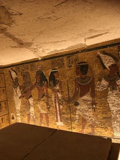 an egyptian mural on the side of a wall in a room that has been painted