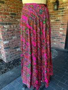 Bright amazing print.  pleats.  side zip. no pockets  waist flat measurement 14" length 39" Spring Paisley Print Flowy Maxi Skirt, Spring Flowy Maxi Skirt With Paisley Print, Bohemian Pleated Relaxed Fit Maxi Skirt, Long Paisley Print Skirt, Flowy Long Paisley Print Skirt, Flowy Long Skirt With Paisley Print, Fitted Long Skirt With Paisley Print, Long Flowy Skirt With Paisley Print, Bohemian Pleated Fitted Maxi Skirt