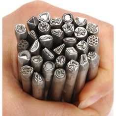 a bunch of metal stamping tools sitting in someone's hand with the words happy supplies on it