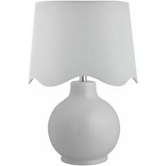 a white table lamp with a white shade on it