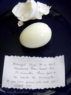 an egg on a plate with a note attached to it