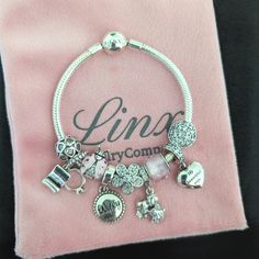 Linx Snake Chain Style Charm Bracelet With A Ball Clasp, Featuring Linx Logo. The Bracelet Comes With 9 Linx Charms As Shown, Including Heart Locket Dangle Charm. *All Items Are 925 Sterling Silver. *Guaranteed Authentic. *Linx Bracelets And Charms Are Very Well Made And Of Superior Quality, Designed To Last. These Pieces Come With A 100% Satisfaction Guarantee Or Your Money Back. *The Bracelet Is Available In Multiple Sizes *Additional Charms Can Also Be Added To The Bracelet And The Ones Inclu White Gold Metal Charm Bracelet For Anniversary, Silver Metal Charm Bracelet, Silver Jewelry With Dangling Charms For Wedding, Elegant Silver Wedding Charms, Wedding Silver Charms, Sterling Silver Charms Bracelets For Wedding, Silver Crystal Bracelet With Jubilee Design As Gift, Sterling Silver Wedding Charms, Silver Chain Wedding Bracelet