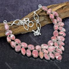 Dive into the magical temptation of this stunning Necklace in attractive shape and design made of Silver Plated studded with Rhodochrosite. An essential ornament to add in your jewellery collection! ----------------------------------- Welcome TO Our Shop Mohan Jewels ----------------------------------- Natural Rhodochrosite Gemstone Necklace, Rhodochrosite Choker Adjustable Silver Plated Necklace Jewelry, Anniversary Gift, Necklace For Her SKU : EQN-311 Gemstone : Rhodochrosite Stone Shape : Pear Metal : Silver Plated Base Metal :- Brass Style : Choker Length : 18 Inches * Jewelry Care Tips:- ----------------------- 1)Avoid Exposure to Moisture:- Remove jewelry before showering, swimming, or doing household chores. Store jewelry in a dry place to prevent tarnishing and corrosion. 2)Minimiz Rhodochrosite Necklace, Pink Stone Necklace, Pink Choker, Necklace For Her, Store Jewelry, Household Chores, Silver Plated Necklace, Silver Plated Jewelry, Stunning Necklace