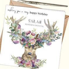 a birthday card featuring an image of a deer with flowers on its antlers