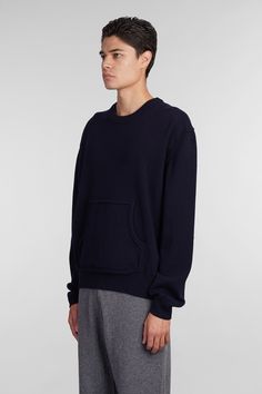 Knitwear in blue wool, round neck, long sleeves, kangaroo pockets, iconic embroidery on the backside, ribbed cuffs and bottom, 70% wool, 30% cashmere, Made in Romania, Model is 1. 83 and wears size M Blue Cashmere Sweater With Ribbed Cuffs, Wool Crew Neck Sweatshirt With Ribbed Cuffs, Navy Wool Sweater With Ribbed Cuffs, Wool Sweatshirt With Ribbed Cuffs And Crew Neck, Crew Neck Cashmere Sweatshirt With Ribbed Cuffs, Fall Crew Neck Sweater With Side Pockets, Navy Wool Crew Neck Sweater, Blue Crew Neck Sweater With Pockets, Blue Sweatshirt With Side Pockets For Fall