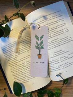 an open book with a plant on it