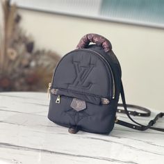 This winter, this Pillow Palm Springs Mini Backpack is made of comfortable padded Econyl recycled nylon and embellished with Monogram embroidery. Loose handles and adjustable canvas shoulder straps provide a variety of wearing options, releasing a dynamic style at home, on the street or at the ski resort.

Dimensions: 17 x 22 x 10 cm Louis Vuitton Pillow, Palm Spring Mini, Mini Black Backpack, Louis Vuitton Palm Springs Mini, Louis Vuitton Yayoi Kusama, Palm Springs Mini Backpack, Lv Backpack, Black Louis Vuitton, Louis Vuitton Capucines