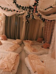 an instagram photo of two beds in a room with white drapes and lights