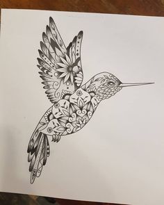 a black and white drawing of a hummingbird with flowers on it's wings