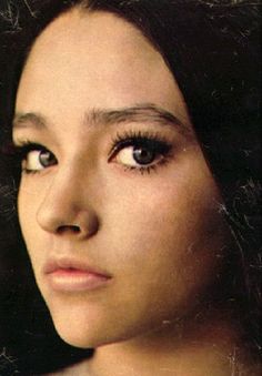 a woman with black hair and big eyes