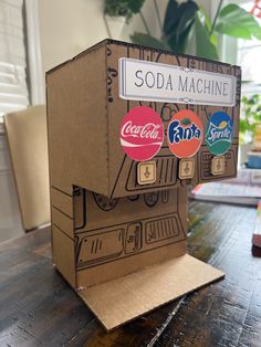 a soda machine sitting on top of a wooden table