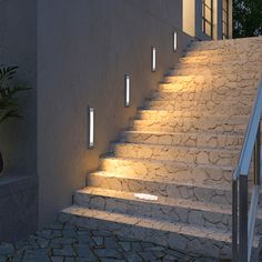 a set of stairs leading up to a building with light coming from the windows on each side