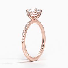 a rose gold engagement ring with diamonds on the side