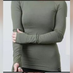 Rokwolf Woman's Workout Lounge Long Sleeve Top Essentials Burnt Olive Green Nwt > Made Of 97% Pima Cotton And 3% Spandex > French Terry Knit Fabric, Giving You Warm And Comfort > Perfect For Colder Weather > Stretchable, Super Soft > Beautiful Fabric > Versatile Top (Can Be Worn As Pajamas, Working Out, Or Athletic Wear Depending On Your Preferences) Color: Burnt Olive/Green Functional Stretch Top For Winter, Fitted Winter Sports Tops, Winter Workout Tops With Thumbholes, Workout Tops With Thumbholes, Green Functional Tops With Thumbholes, Midweight Solid Color Winter Tops, Winter Yoga Tops With Thumbholes, Stretch Tops For Gym In Winter, Functional Snug Fit Tops With Thumbholes