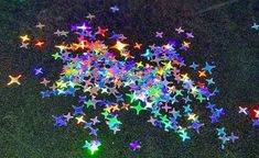 many different colored stars on the ground with one light turned on and two lit up