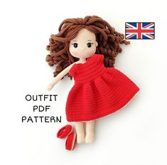 a crocheted doll with brown hair and red dress is laying on the floor