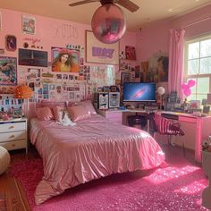 a bedroom with pink walls and lots of pictures on the wall, including a bed