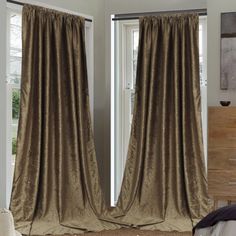 the curtains in this bedroom are drapes open