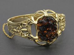 "Beautiful Art Nouveau style bracelet by Whiting and Davis with a contrasting geode style rhinestone centerpiece. I love the contrast that this element provides. Closes with a push in clasp and safety chain that is secured with a safety chain. SIZE/CONDITION: Like new condition. Fits a small to small/medium wrist size. (Mine is 6.25\" around and is about the largest that would fit.) About 1.5\" from top to bottom in the front. LINKS: Looking for a VINTAGE BRACELET, and this isn't the one? Click Vintage Gold Bangle With Gemstone, Collectible Costume Jewelry Bangle, Vintage Gemstone Cuff Bracelet Bangle, Vintage Gemstone Cuff Bracelet, Vintage Cabochon Bangle Jewelry, Formal Faceted Bangle Jewelry, Vintage Gemstone Bangle For Formal Occasions, Gold Vintage Bracelet, Vintage Gold Bracelet