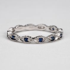 Round sapphires in a marquise shape with milgrain on the edge makes it delicate vintage inspired wedding, anniversary or a stacking ring. We can make this with any gemstone or 3/4 or full eternity. Customization requests are welcome. Details: - Default width is 2.5mm. - Default thickness is 1.85mm. - Default finish is high polish. If you want it matte or brushed leave us a note at checkout. - Contact us for a quote if your ring size is greater than 9. - White gold is rhodium plated by default. I Elegant Sapphire Eternity Band For Anniversary, Elegant Half Eternity Marquise Cut Band, Elegant Marquise Cut Half Eternity Band, Classic Sapphire Eternity Band For Wedding, Elegant Sapphire Stackable Eternity Band, White Gold Sapphire Eternity Band, Yellow Gold Sapphire Eternity Band For Promise, Elegant Sapphire Eternity Band With Round Cut, Elegant Sapphire Eternity Band