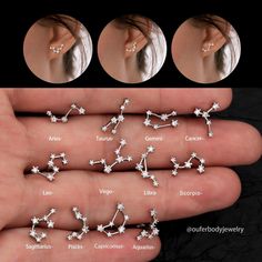 four different types of ear piercings on someone's hand, including one with stars