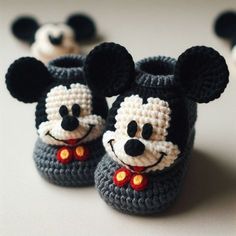 crocheted mickey mouse slippers are shown on a table