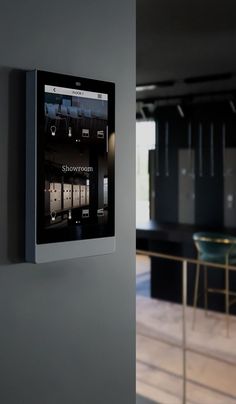 an appliance mounted on the wall in a kitchen area with bar stools