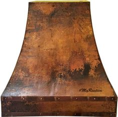 an old rusted metal stove hood with writing on it