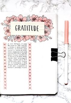 an open notebook with pink flowers and the words gratitude written on it