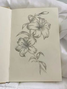 an open book with flowers drawn on it