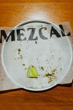 a plate that has some kind of food on it with the word mezcal written on it