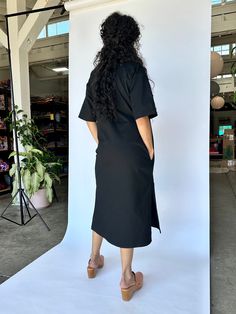 This dress is made for working. Just pull it over and zip it up. Two breast pockets, two side pockets and some high slits so you can move. It's an oversized, unisex boxy fit so we've sized it in hopes of accommodating a lot of people. This solid black work dress is made in our soft brushed twill, a heavier fabric with slight stretch. Black Work Dress, Black Work Dresses, Black Work, Work Dress, Running Women, Blackwork, Solid Black, Dress Black, Dresses For Work