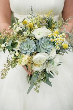 a wedding bouquet with succulents and greenery is featured in this article