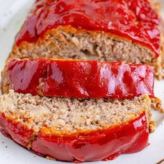 sliced meatloaf on a plate with ketchup