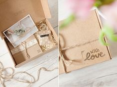 an open box with some items inside on a white wooden floor and in front of it is a pink flower