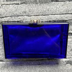 Charlotte Olimpia Royal Blue Plexi Clutch With Crystal Spider Clasp Blue Formal Bags With Gold-tone Hardware, Designer Blue Rectangular Case Bag, Formal Blue Bags With Gold-tone Hardware, Designer Blue Bag For Formal Occasions, Elegant Royal Blue Rectangular Bag, Blue Rectangular Evening Bag For Events, Luxury Blue Bag For Events, Royal Blue Rectangular Evening Bag, Blue Clutch Evening Bag For Formal Occasions