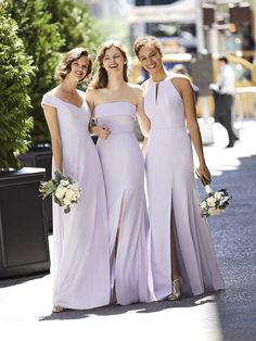 three bridesmaids in lavender dresses posing for the camera