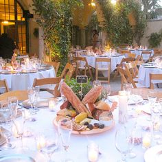 an outdoor dining area with tables and chairs set up for a formal function in the evening