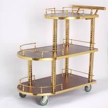 three tiered brass plated serving cart on wheels with handles and two trays