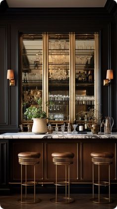 an elegant bar with three stools in front of it