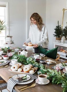 a woman standing in front of a table filled with food