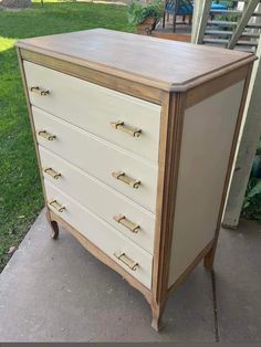 an old dresser is painted white and brown