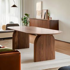 a living room filled with furniture and a large wooden table in the middle of it