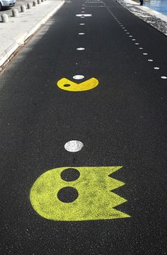 the street is painted with smiley faces and lightning bolt symbols in yellow, black, and white