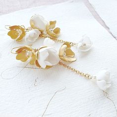 Pair of delicate smooth vine earrings. ❤️ earrings length is approx 3.2 inches (8 cm) and 0.6 inch (1,5 cm) wide ❤️ earring's closure - ear wire/hook ❤️ 24k gold plated brass and stainless steel, pearls, Toho beads and hand created foam flowers ❤️ different color option available - ask for details ❤️ ships within 5 days ❤️ worldwide free shipping 💝 earrings will be shipped nicely packed in the gift box For other wedding jewelry visit my shop: https://www.etsy.com/shop/byPiLLowDesign White Dangle Bridal Earrings, White Long Drop Chandelier Earrings For Wedding, Elegant Handmade Flower Drop Bridal Earrings, Delicate White Chandelier Drop Earrings, Delicate Petal-shaped Flower Earrings For Wedding, Elegant Handmade Flower Bridal Drop Earrings, Elegant Bridal Earrings With Handmade Gold Flowers, Graceful White Dangle Bridal Earrings, Elegant Gold Bridal Earrings With Handmade Flowers