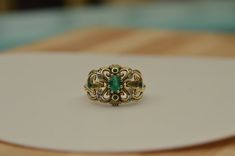 This stunning ring is my last and favorite design . 14k gold ring with emerald and diamonds . Central emerald stone weight : 0.6 carat . Diamond weight : 0.12 carat . Weight ring : 4.2 gram . Top ring length : 2 centimeter . Top ring width : 1.4 centimeter . Elegant 14k Stamped Emerald Ring, Fine Jewelry Emerald Ring With Intricate Design, Emerald Ring With Intricate Design, Fine Jewelry Rings For Anniversary With Jewels, Victorian Green Jewelry Stamped 14k, Fine Jewelry Rings For Anniversary, Anniversary Fine Jewelry Rings With Jewels, Exquisite Green Emerald Ring In 14k Gold, Exquisite 14k Gold Green Emerald Ring