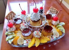 a platter filled with cupcakes and fruit