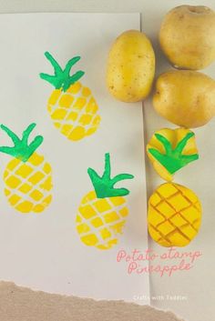 three pineapples and two pears on a piece of paper next to potatoes